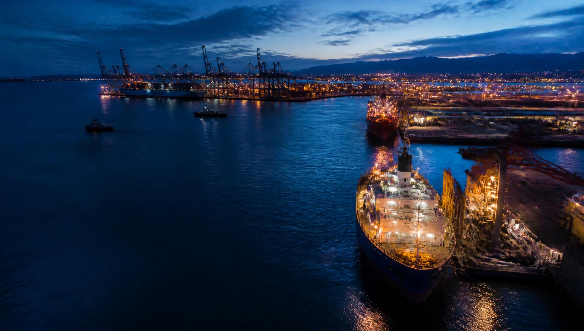 Middle East, India and Africa container port and offshore vessels at blue hour